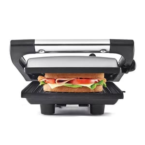 Panini press with a sandwich featuring lettuce, tomato, cheese, and deli meat.