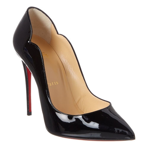 A black patent leather high-heeled stiletto shoe with a pointed toe and red sole.
