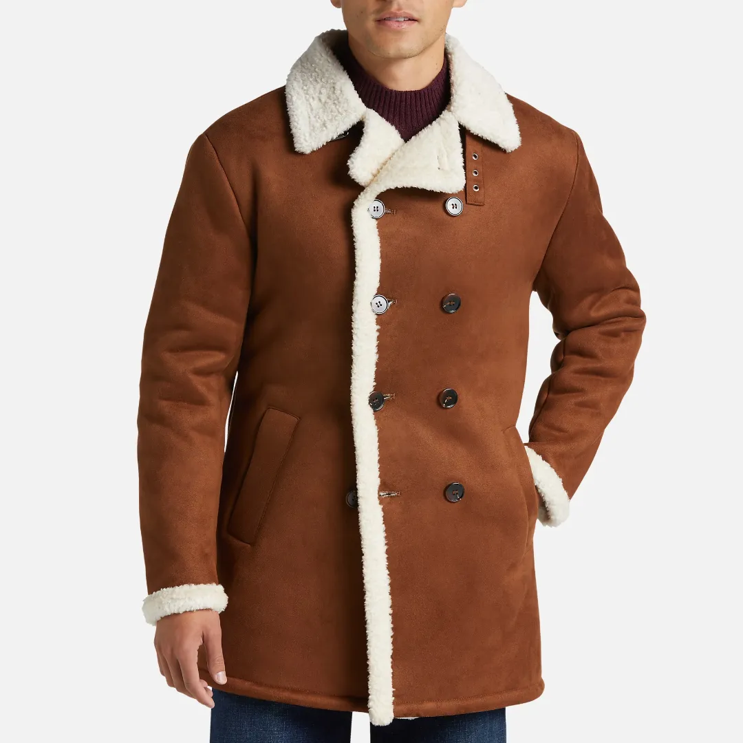A man wearing a brown shearling coat with white lining and a dark purple sweater.