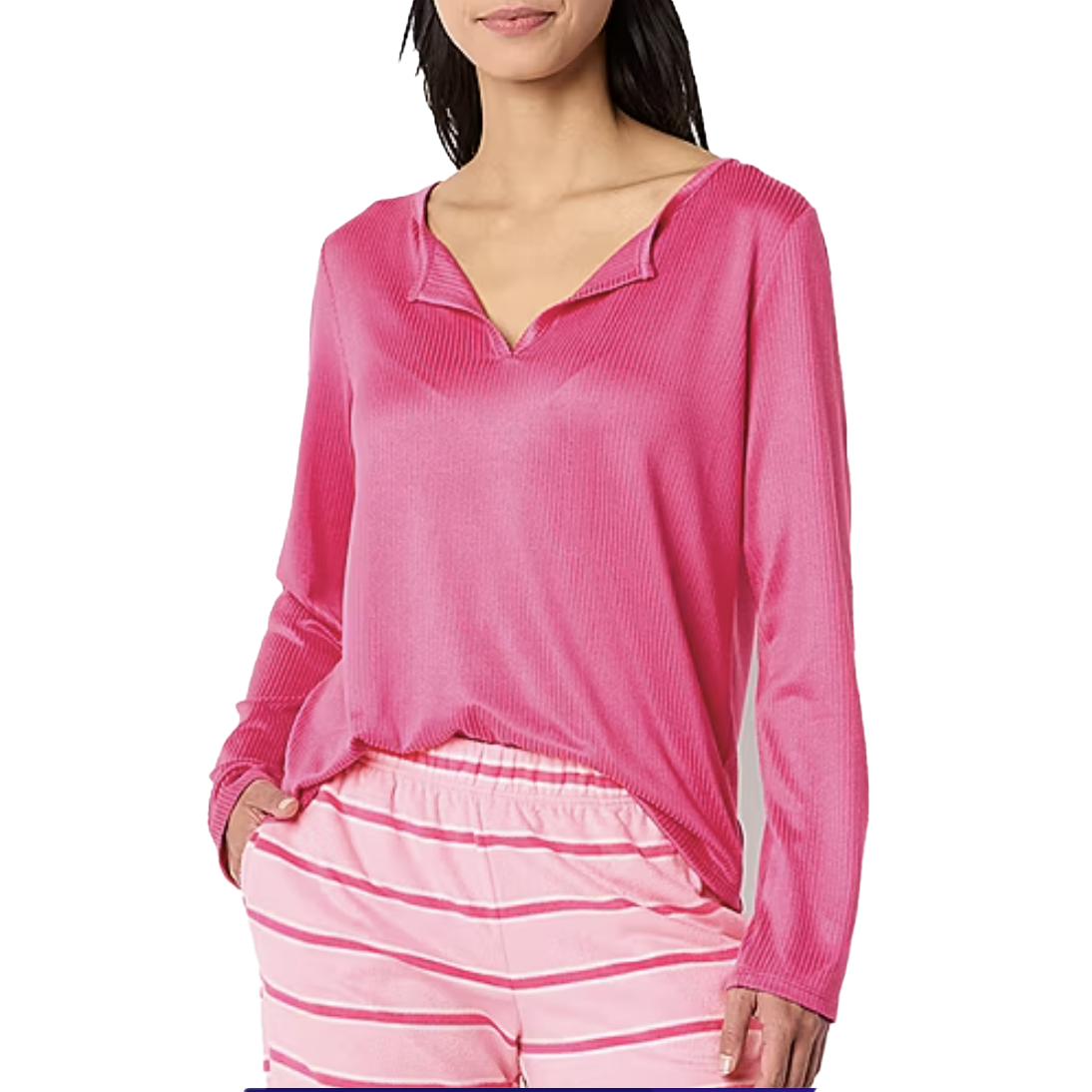 A bright pink, velour ribbed sleep top with a relaxed fit and long sleeves, featuring a V-neckline. Paired with matching striped pajama bottoms.