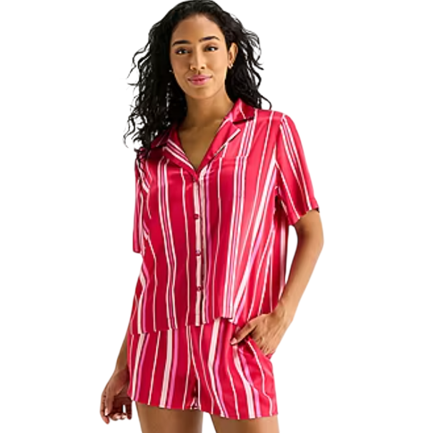A woman is wearing a red and white vertically striped short-sleeve button-up top with matching shorts.