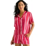 A woman is wearing a red and white vertically striped short-sleeve button-up top with matching shorts.