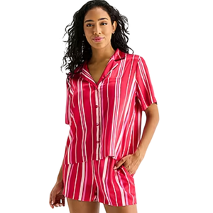 A woman is wearing a red and white vertically striped short-sleeve button-up top with matching shorts.