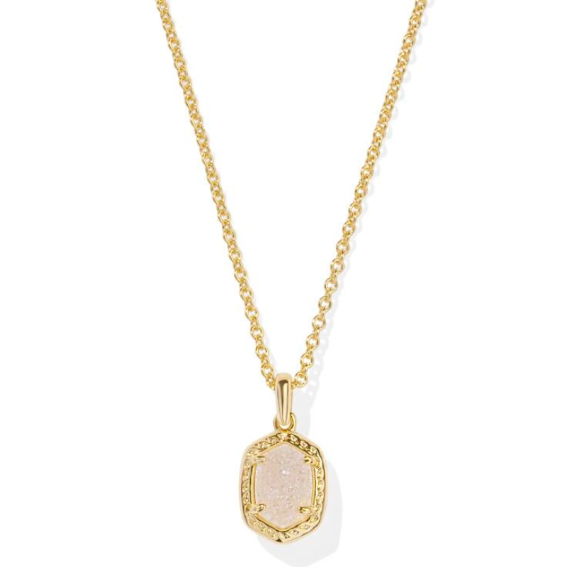 A gold chain necklace features an oval-shaped, textured stone set within a decorative gold frame. The pendant has a simple yet elegant design.