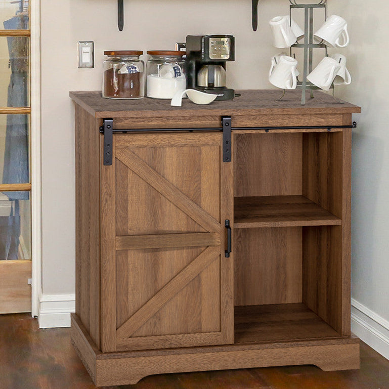 Wooden cabinet with a sliding barn door houses shelves on one side; coffee maker, jars, and a mug tree stand on top.