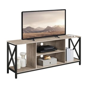 A TV stand with a mounted flat-screen TV features a beige wood finish and black metal frame. It includes shelves for media equipment and decorative items, with books and vases placed on the lower shelves.