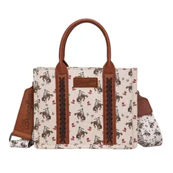 A beige tote bag with brown leather accents featuring a cowboy and horse pattern, and \“Wrangler\“ branding on the bag and detachable shoulder strap.