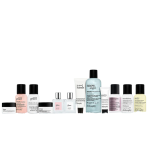 A collection of Philosophy brand skincare and fragrance products displayed on a snowy background, including lotions, perfumes, and creams in various bottles and tubes. Products are named \“grace,\“ \“hope,\“ \“purity,\“ and \“snow angel.\“