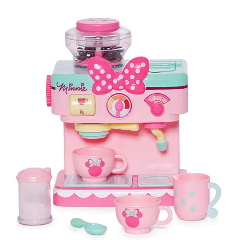 Pink and teal toy coffee maker with Minnie Mouse theme, featuring cups, a milk jug, and a sugar container, adorned with Minnie logos and bows.
