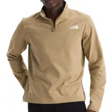 A beige quarter-zip pullover by The North Face, featuring a high collar and logo on the chest, worn by a person with hands on hips.