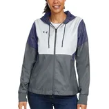 A woman wearing a color-blocked hooded jacket with shades of purple, white, and gray, featuring a small logo on the chest, paired with blue jeans.