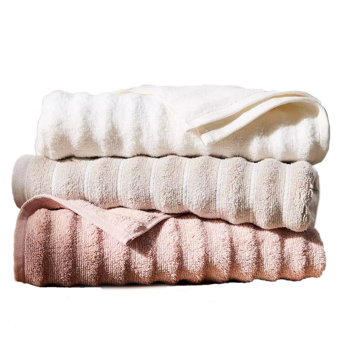 Three stacked towels in shades of white, beige, and pink.