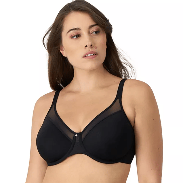 A woman is wearing a black bra with mesh details at the top of the cups and adjustable straps, providing a supportive and stylish look.