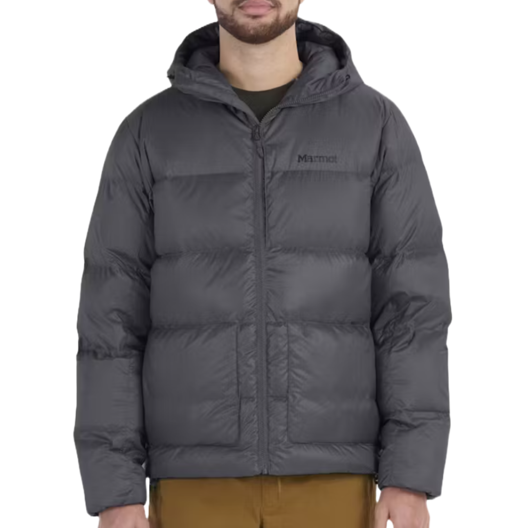 Marmot Guides Down Jacket is a durable, insulated jacket designed for cold weather, featuring a puffer style with a high collar, adjustable hood, and front zipper. It's dark in color with the Marmot logo on the chest.