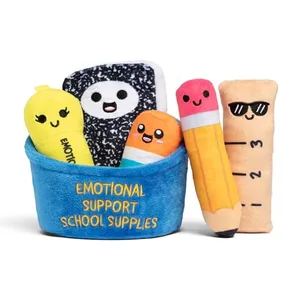 Plush toys resembling a light bulb, notebook, crayon, pencil, and ruler sit in a blue holder labeled \“Emotional Support School Supplies.\“