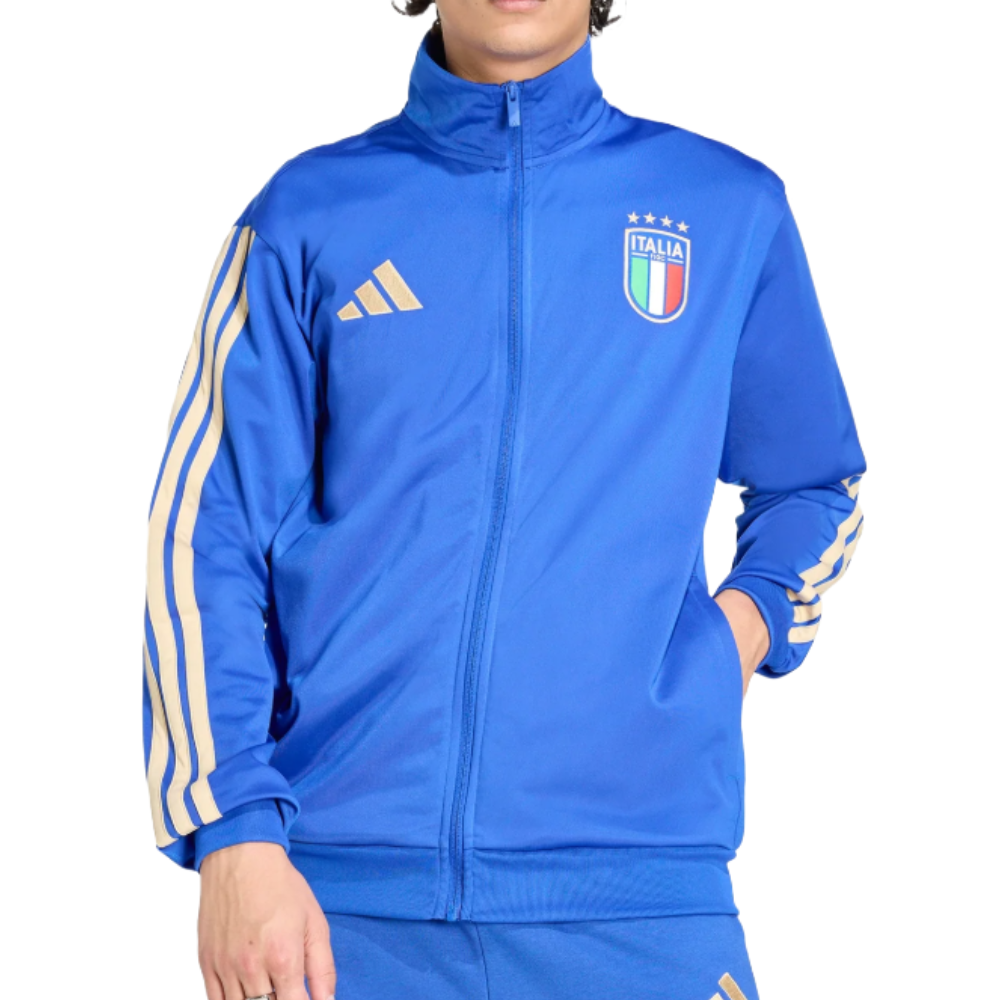 A blue track jacket featuring the Italy national soccer team logo, with beige Adidas stripes on the sleeves and the Adidas logo on the chest.