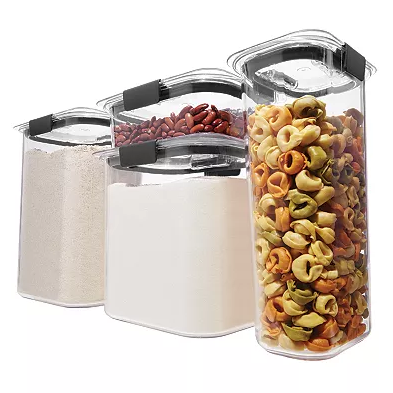 Eight clear plastic containers with black latches and airtight lids, holding various dry foods like pasta, flour, and beans.