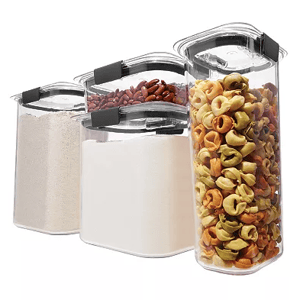Eight clear plastic containers with black latches and airtight lids, holding various dry foods like pasta, flour, and beans.