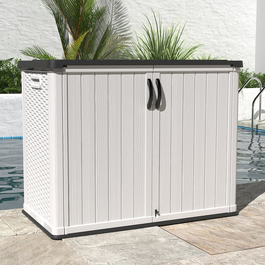 A white patio storage box with a wood-like texture, featuring two handles and a lockable double-door design. Ideal for outdoor storage by the poolside.