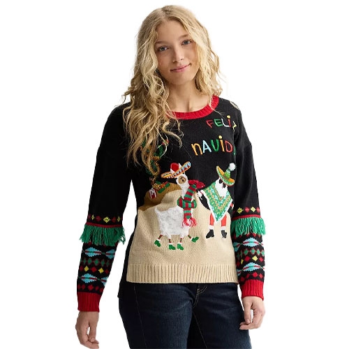 A person wears a festive black sweater featuring llamas with holiday accessories, red and green fringe, and \“Feliz Navidad\“ text.