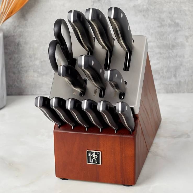 J.A. Henckels 14-piece knife set includes various knives, scissors, and a wood block with labeled slots. The knives have black handles with silver accents.