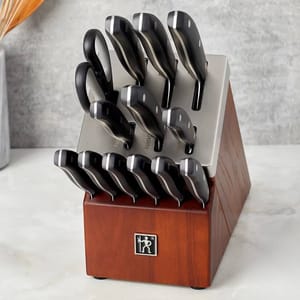 J.A. Henckels 14-piece knife set includes various knives, scissors, and a wood block with labeled slots. The knives have black handles with silver accents.