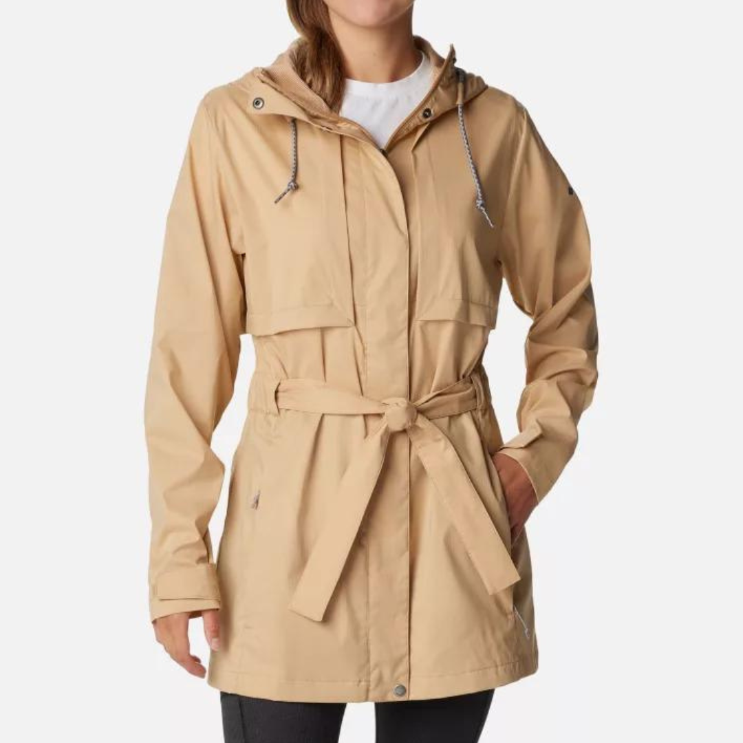 A woman is wearing a beige raincoat with a hood and a waist tie.