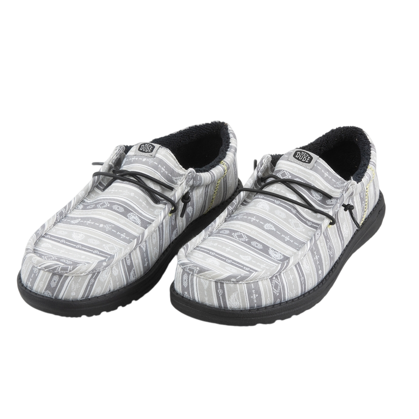 Casual slip-on shoes with a patterned gray and white fabric upper, featuring black laces and a dark sole. The shoes have a cozy, padded interior, likely designed for comfort.