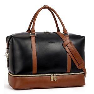 A black and brown 18\“ weekender bag with dual handles, buckle accents, and an adjustable shoulder strap. Features include a spacious main compartment and a separate zippered shoe pocket at the bottom.