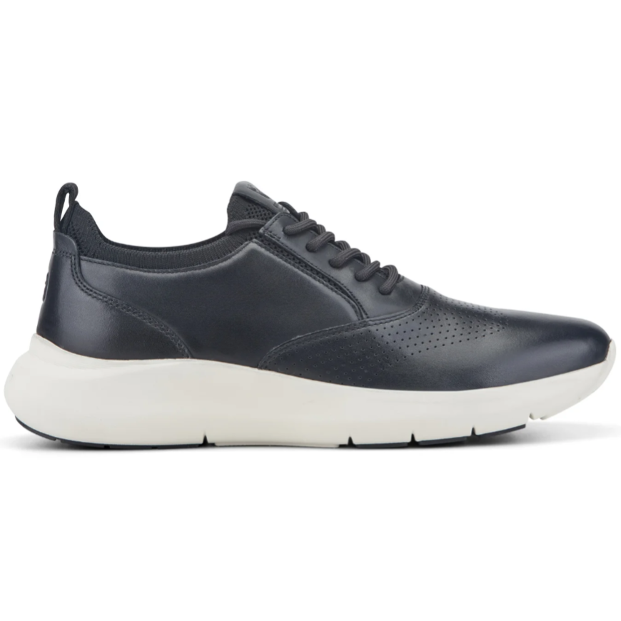 A sleek, dark navy sneaker with perforated detailing and a contrasting white sole featuring a low top design and lace-up closure.