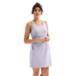 Woman wearing a sleeveless, lavender sports dress with a scoop neckline and side pockets.