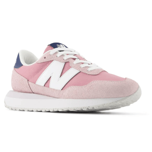 Pink New Balance sneaker with white logo, white laces, and a white sole, featuring blue accents on the heel and tongue.