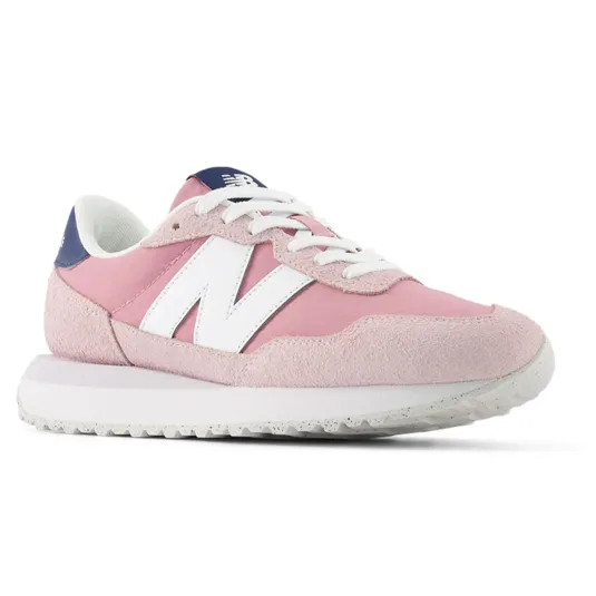 Pink New Balance sneaker with white logo, white laces, and a white sole, featuring blue accents on the heel and tongue.