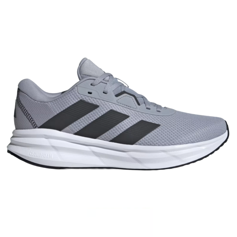 A gray athletic sneaker with three black stripes, featuring a mesh upper and a white Cloudfoam sole.
