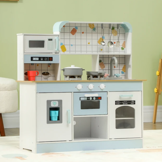 Wooden play kitchen set with stove, oven, microwave, and sink, featuring light blue accents. Kitchenware and playful fruit designs decorate the backdrop.