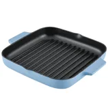 A square, blue grill pan with handles, featuring a ribbed surface.