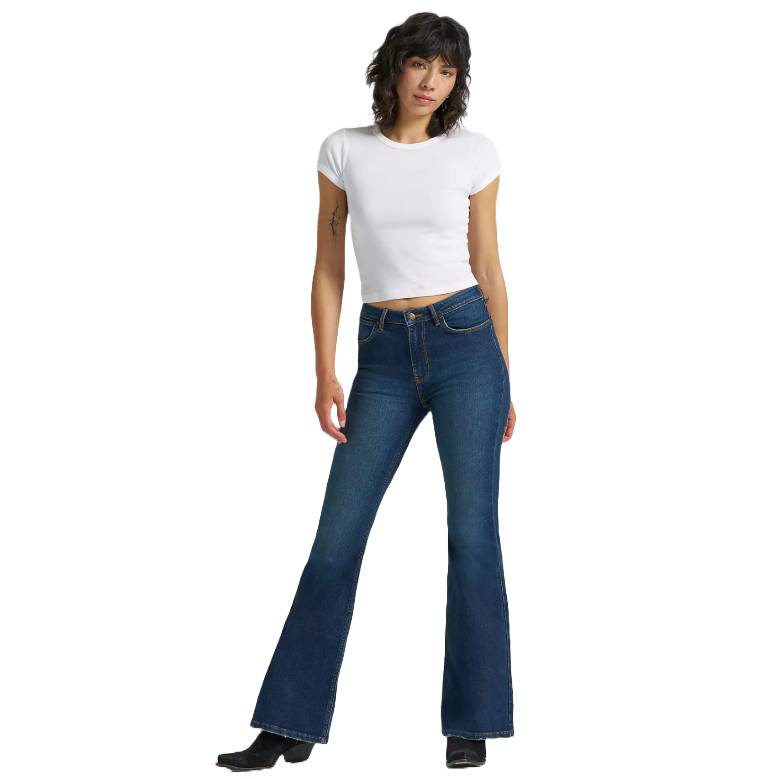 A person is wearing a white crop top and high-waisted, flared blue jeans with black boots.