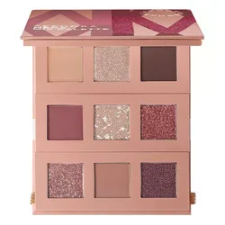 An eyeshadow palette featuring three rows of different shades, including matte and shimmery colors in neutral and pink hues.