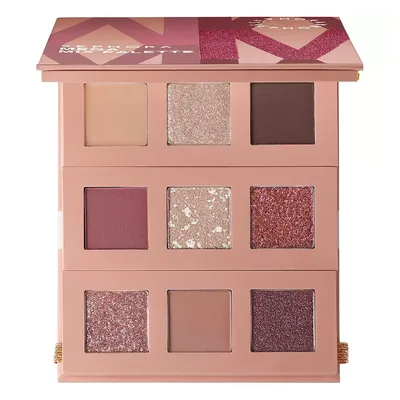 An eyeshadow palette featuring three rows of different shades, including matte and shimmery colors in neutral and pink hues.