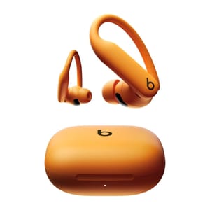 Orange wireless earphones with ear hooks and a matching charging case, featuring the Beats logo.
