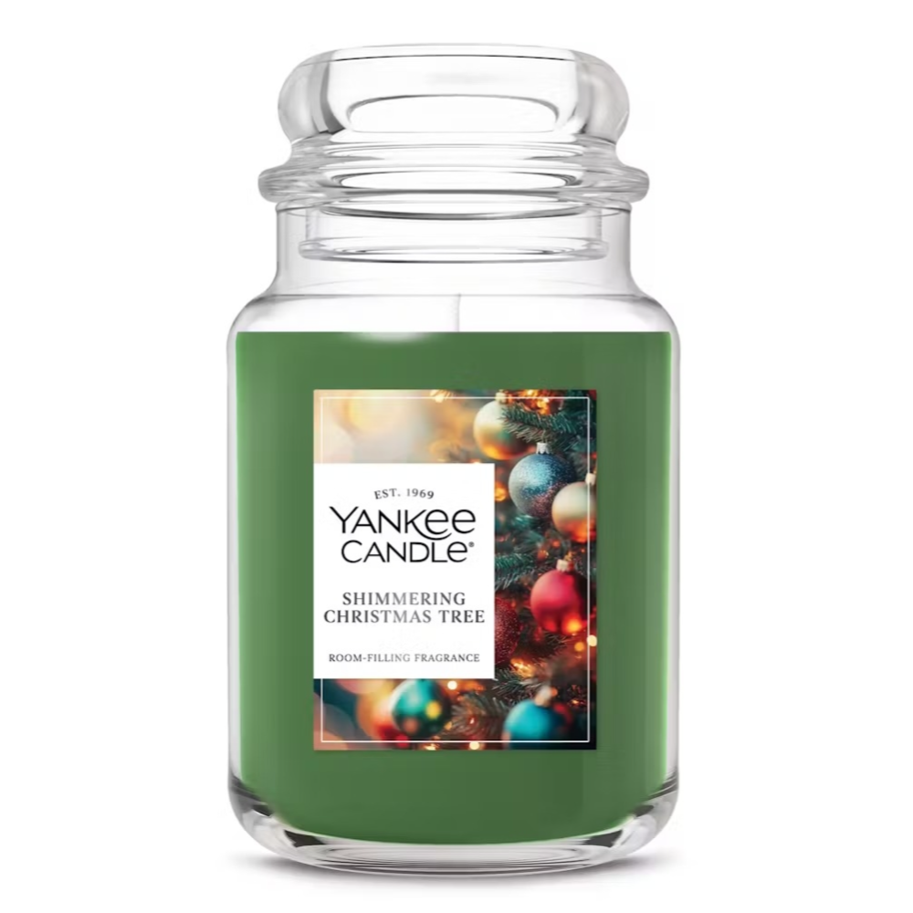 A Yankee Candle in the \“Shimmering Christmas Tree\“ fragrance, featuring a green color and holiday-themed label.