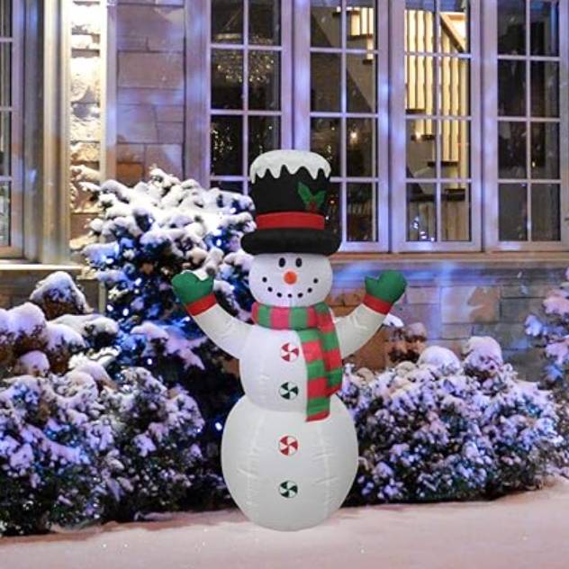 Inflatable snowman decoration with a top hat and scarf, placed in a snow-covered outdoor setting.