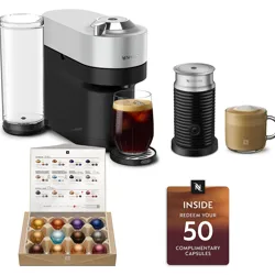 Nespresso coffee maker with a frother, two prepared drinks, a variety box of capsules, and a card offering redemption for 50 complimentary capsules.