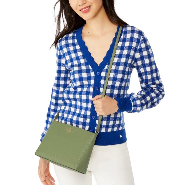 A person is wearing a blue and white checkered cardigan and holding a green crossbody bag.
