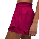 A pair of magenta athletic shorts with an elastic waistband and overlapping hem, featuring the Lululemon logo.