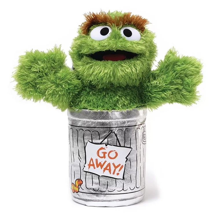 Gund Oscar the Grouch plushie features a green, furry character with wide eyes and a mouth, emerging from a silver trash can with a \“GO AWAY!\“ sign.