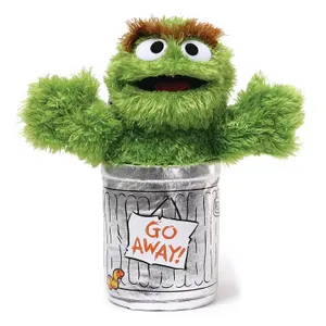 Gund Oscar the Grouch plushie features a green, furry character with wide eyes and a mouth, emerging from a silver trash can with a \“GO AWAY!\“ sign.