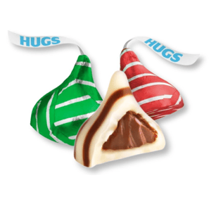 Hershey's Hugs candies wrapped in green and red striped foil, with a cross-section showing milk chocolate inside and white creme with stripes on the outside.
