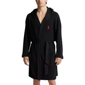 A black waffle-knit bathrobe with a hood and a red embroidered logo on the chest, featuring front pockets and a waist belt.
