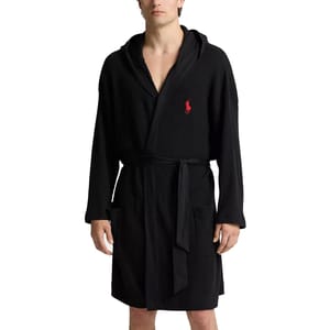A black waffle-knit bathrobe with a hood and a red embroidered logo on the chest, featuring front pockets and a waist belt.